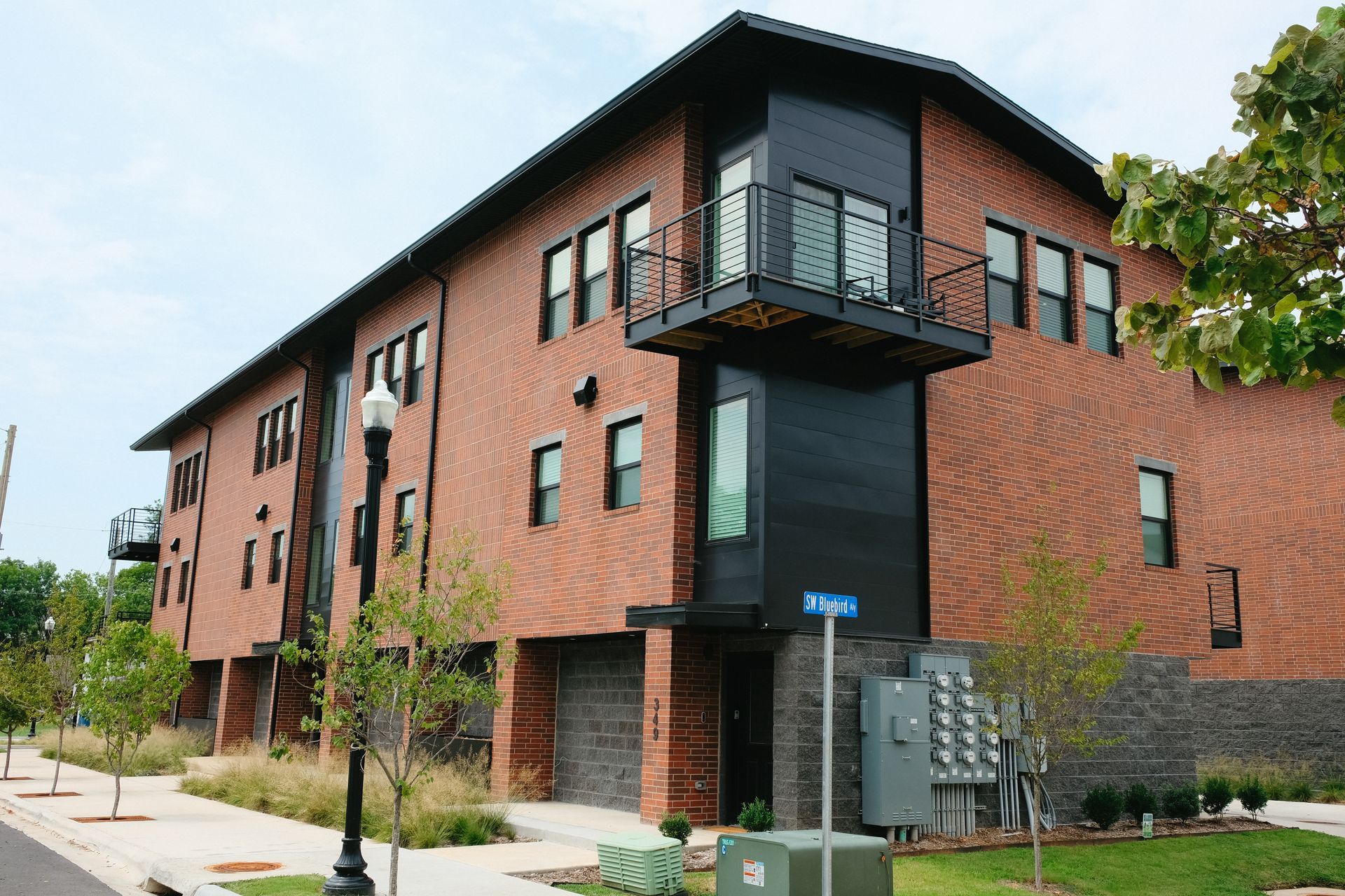 A large brick building with a balcony on top of it.