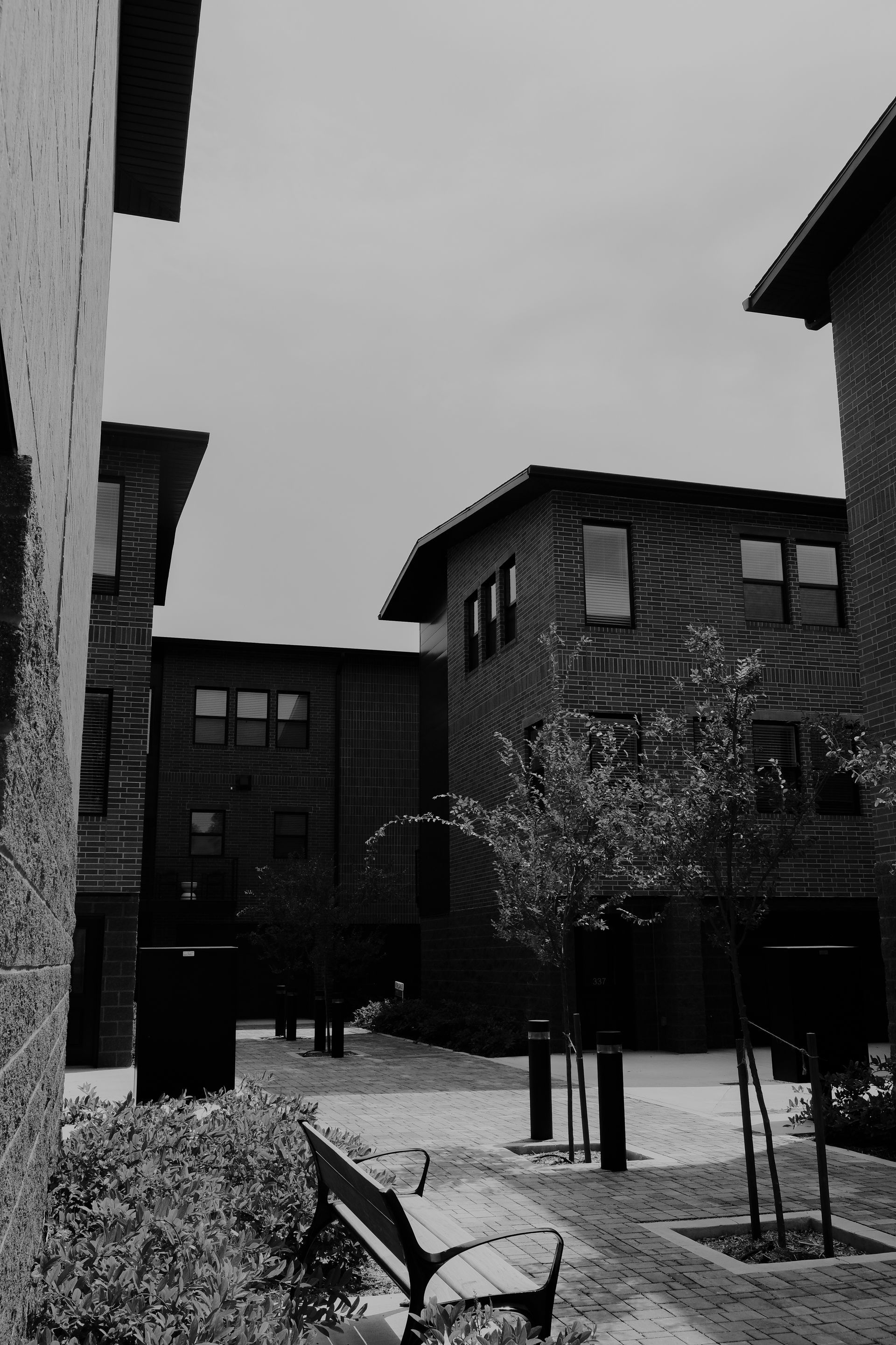 A black and white photo of a row of brick buildings