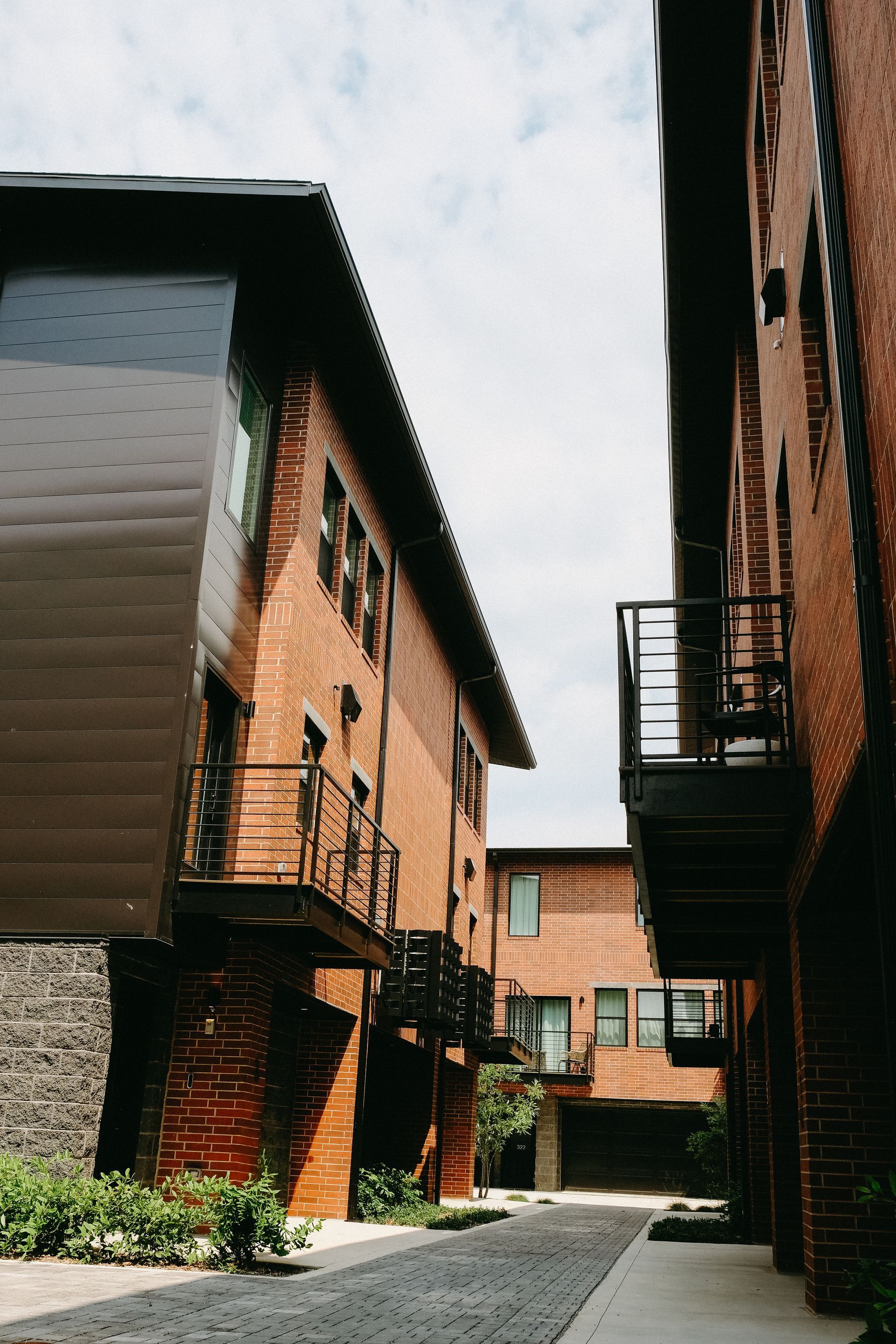 A narrow alleyway between two brick buildings