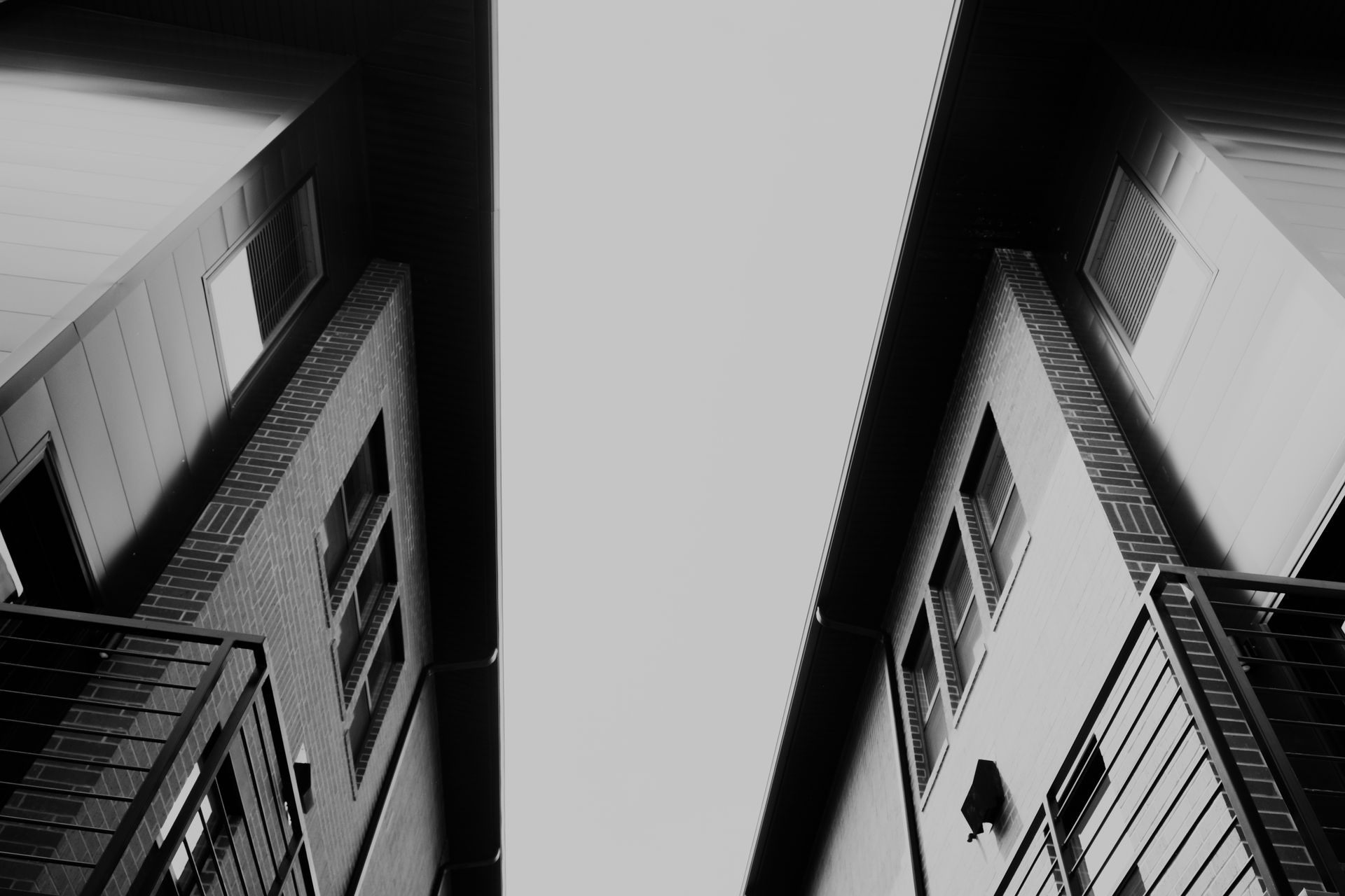 A black and white photo of a building with fire escapes