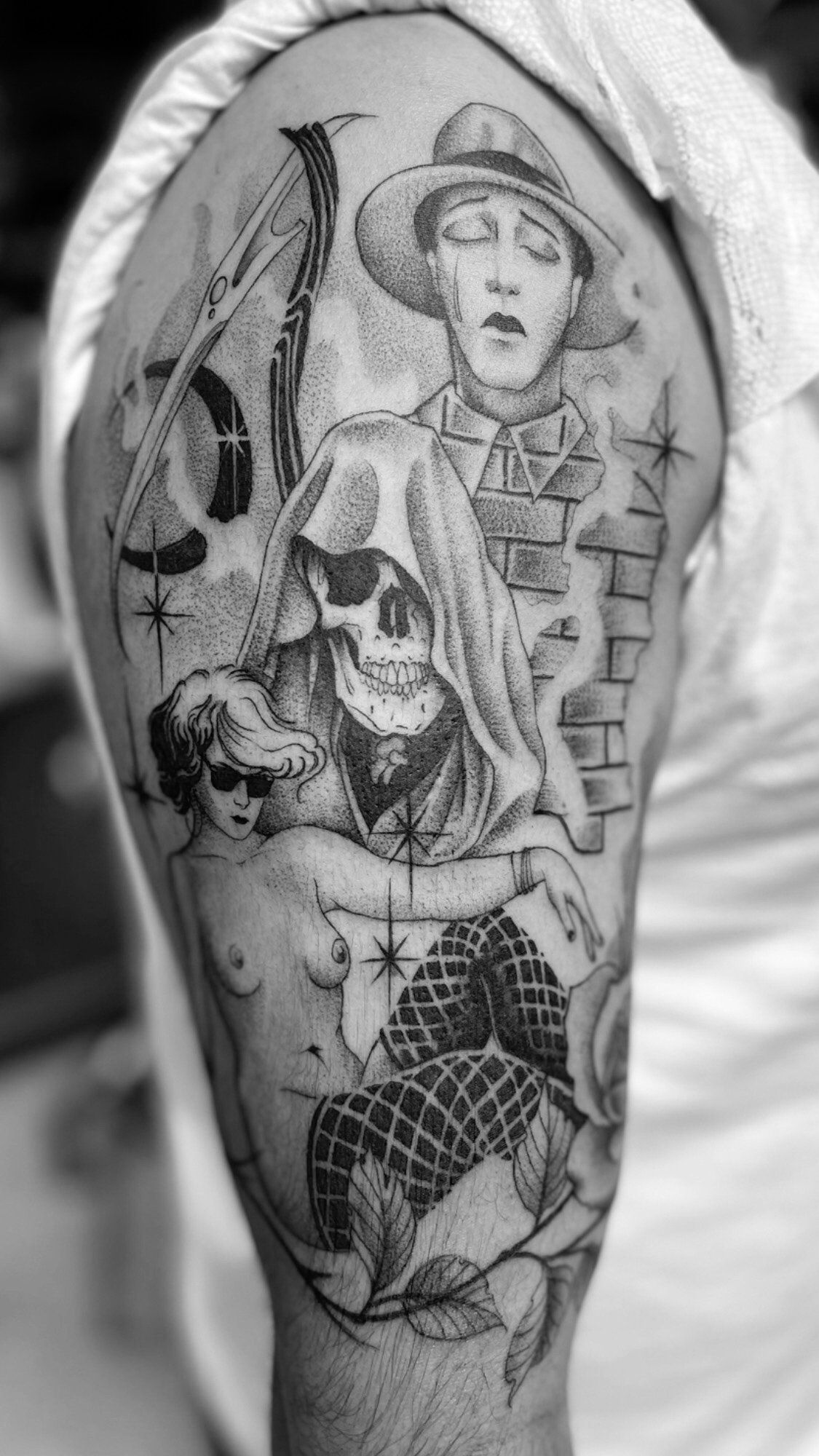 A black and white photo of a tattoo on a man 's arm.