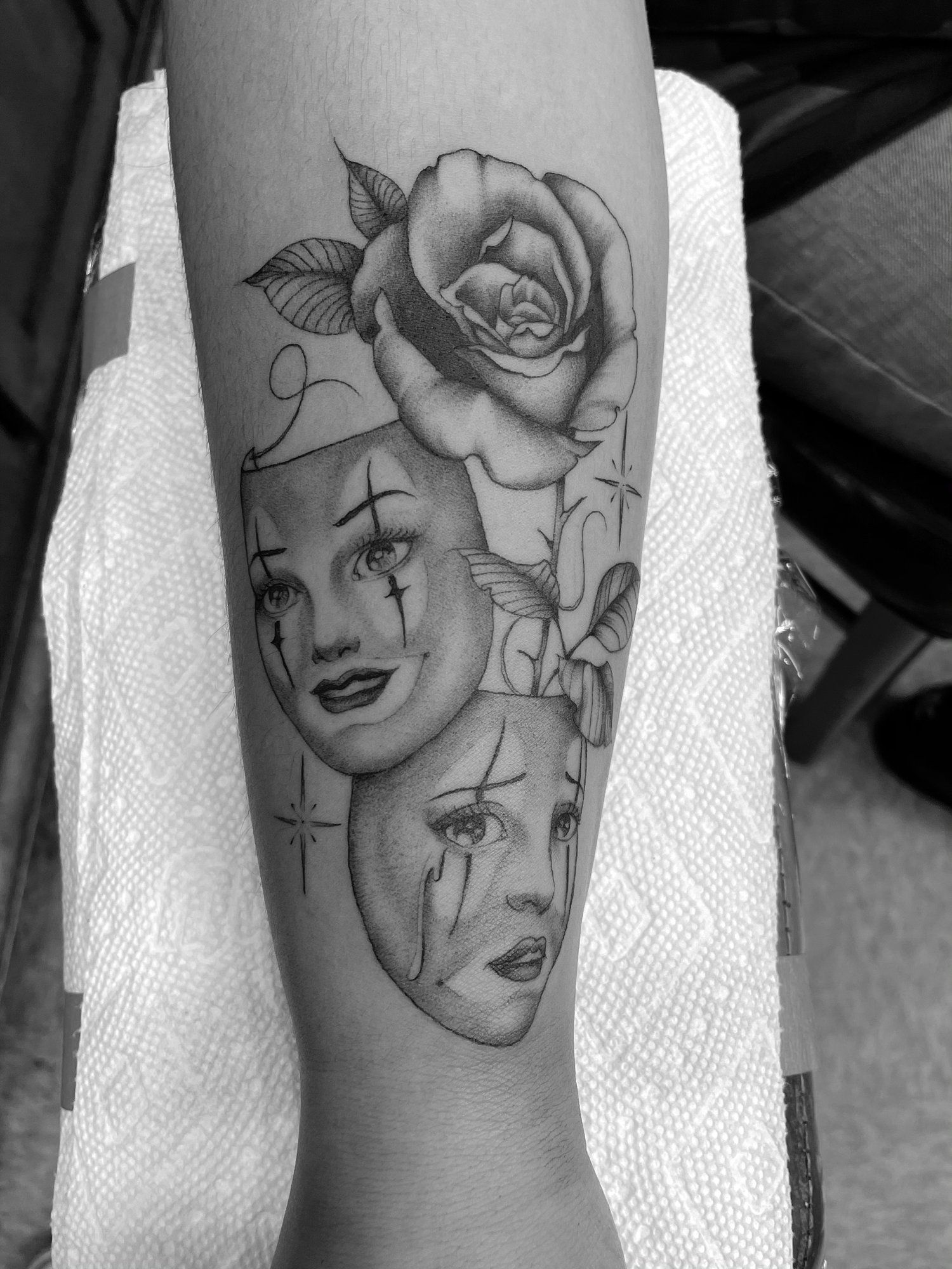 A black and white photo of a tattoo on a person 's arm