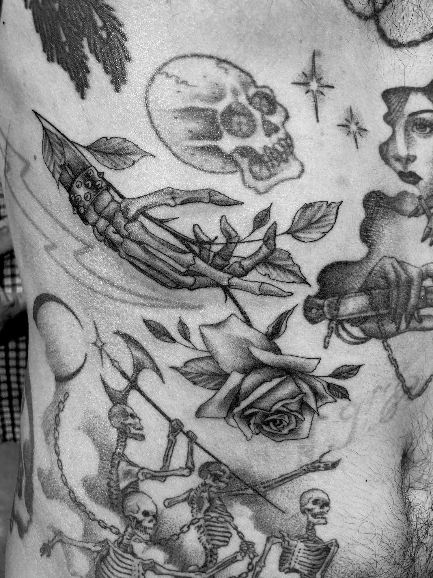 A black and white photo of a tattoo on a person 's chest