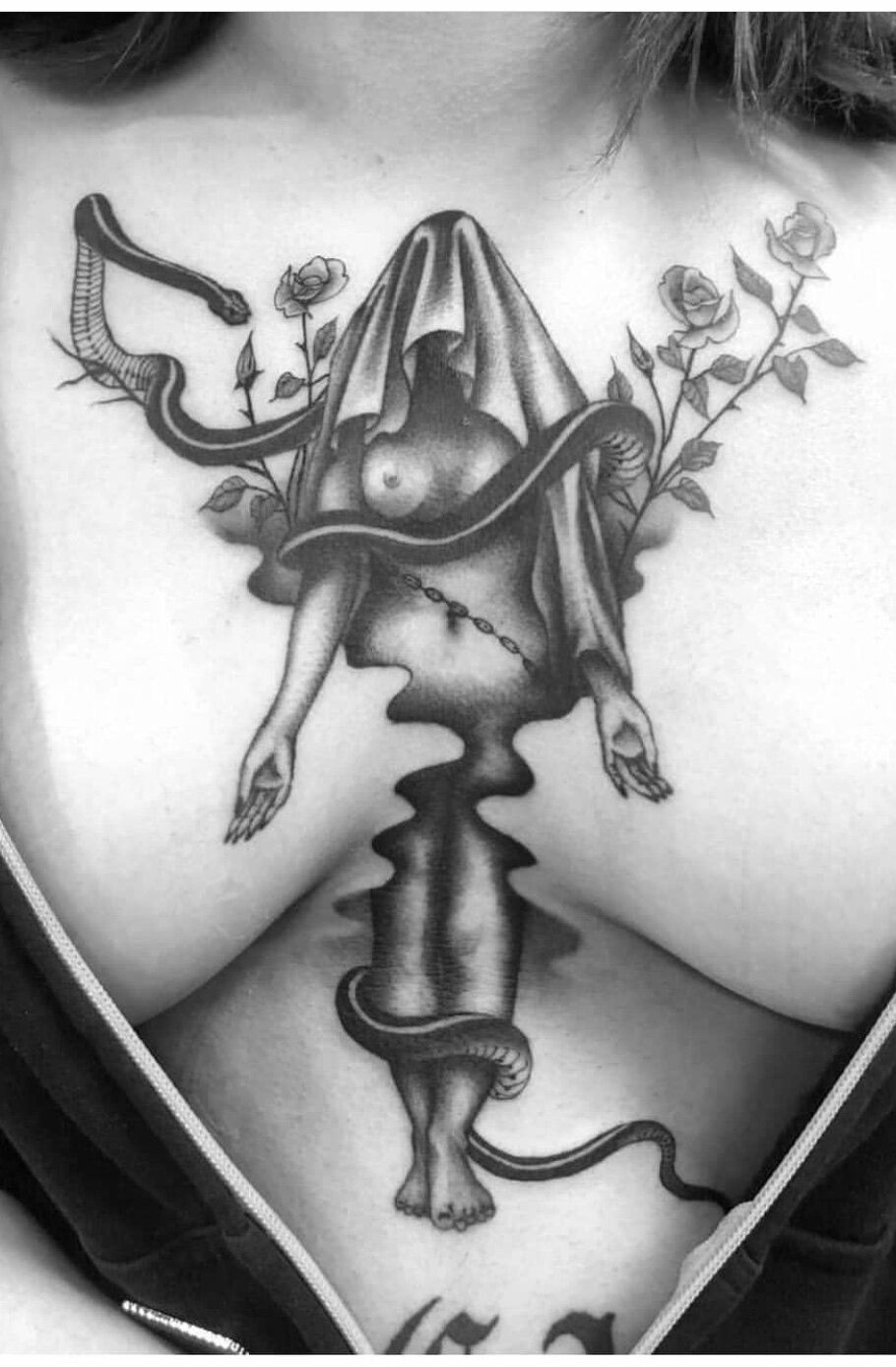 A woman has a tattoo of a woman with a snake around her neck