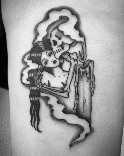 A black and white tattoo of a skeleton kissing a woman
