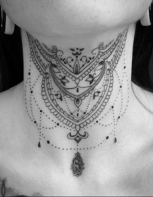 A woman has a tattoo on her neck that looks like a necklace