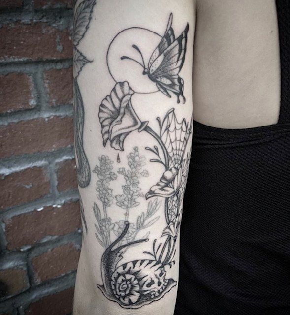 A woman has a tattoo of a butterfly on her arm