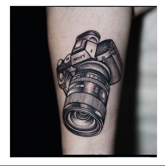 A tattoo of a sony camera on a person 's leg