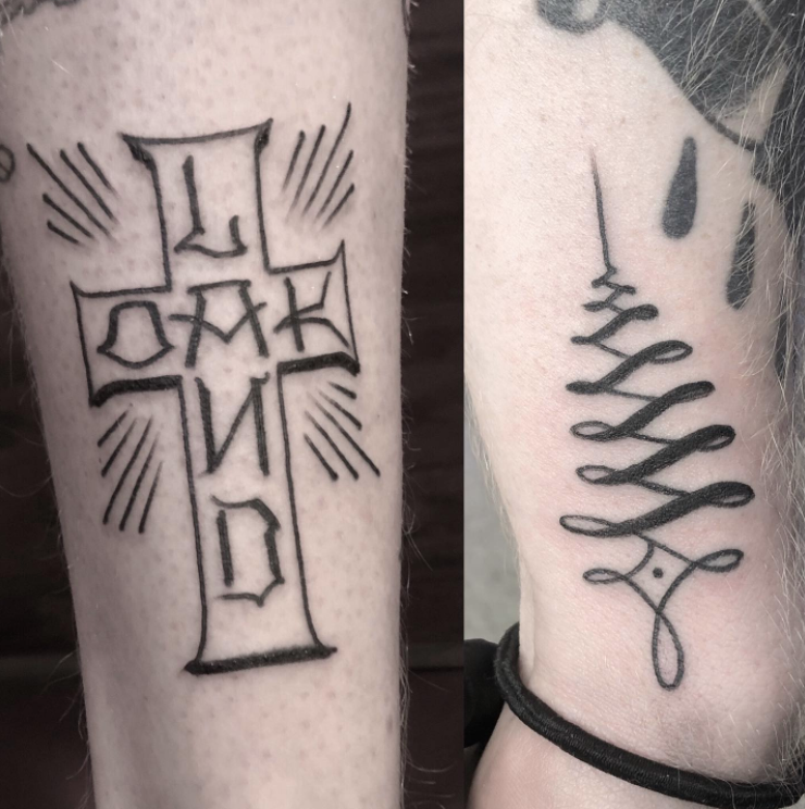 A person has a cross tattoo on their leg