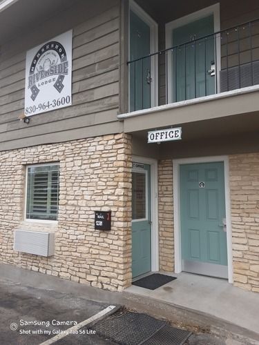 Exterior of Hillside Lodge with stone facade, turquoise doors, and 