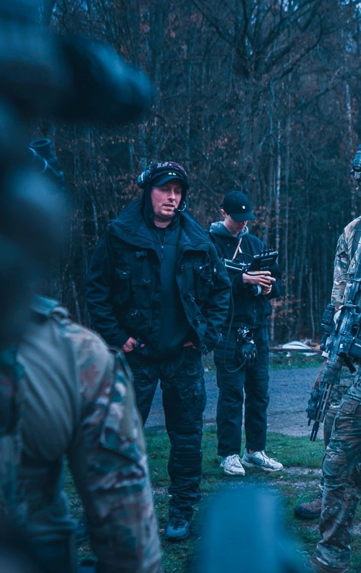 Ferdi Fischer directing a tactical commercial film scene alongside real military operators on set.
