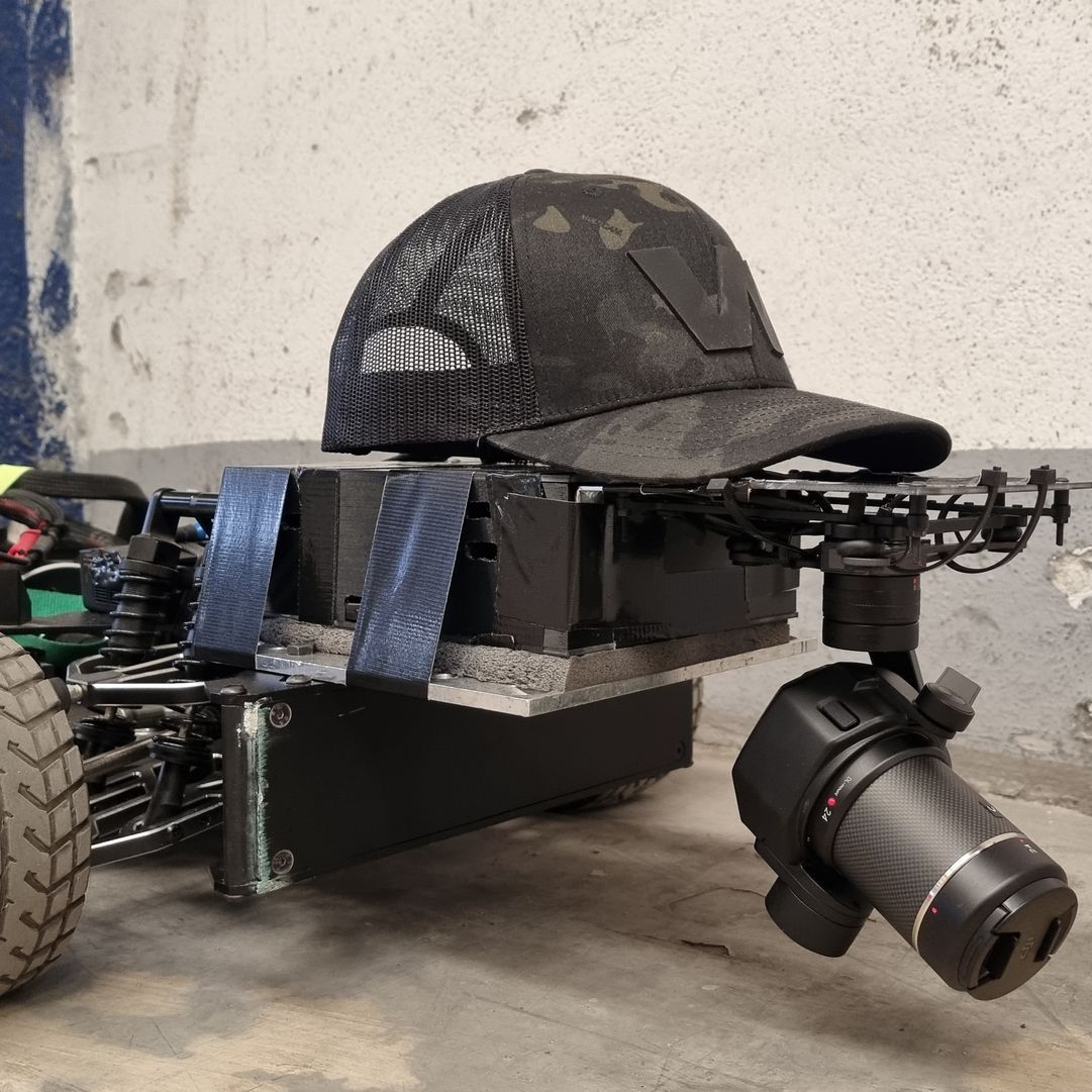 WarpCam® mounted on an RC car, navigating beneath roaring vehicle engines.
