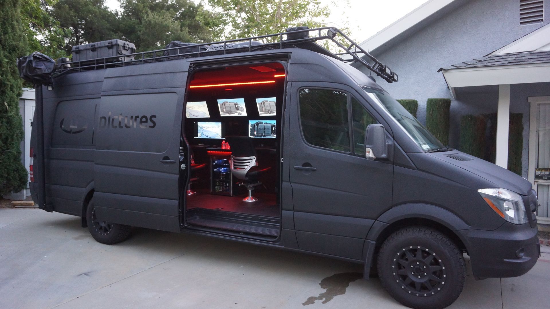 Full view of the Tactical Mobile Workspace, emphasizing its strategic mobility, with specialized work areas and multiple display monitors for real-time surveillance and operational efficiency.