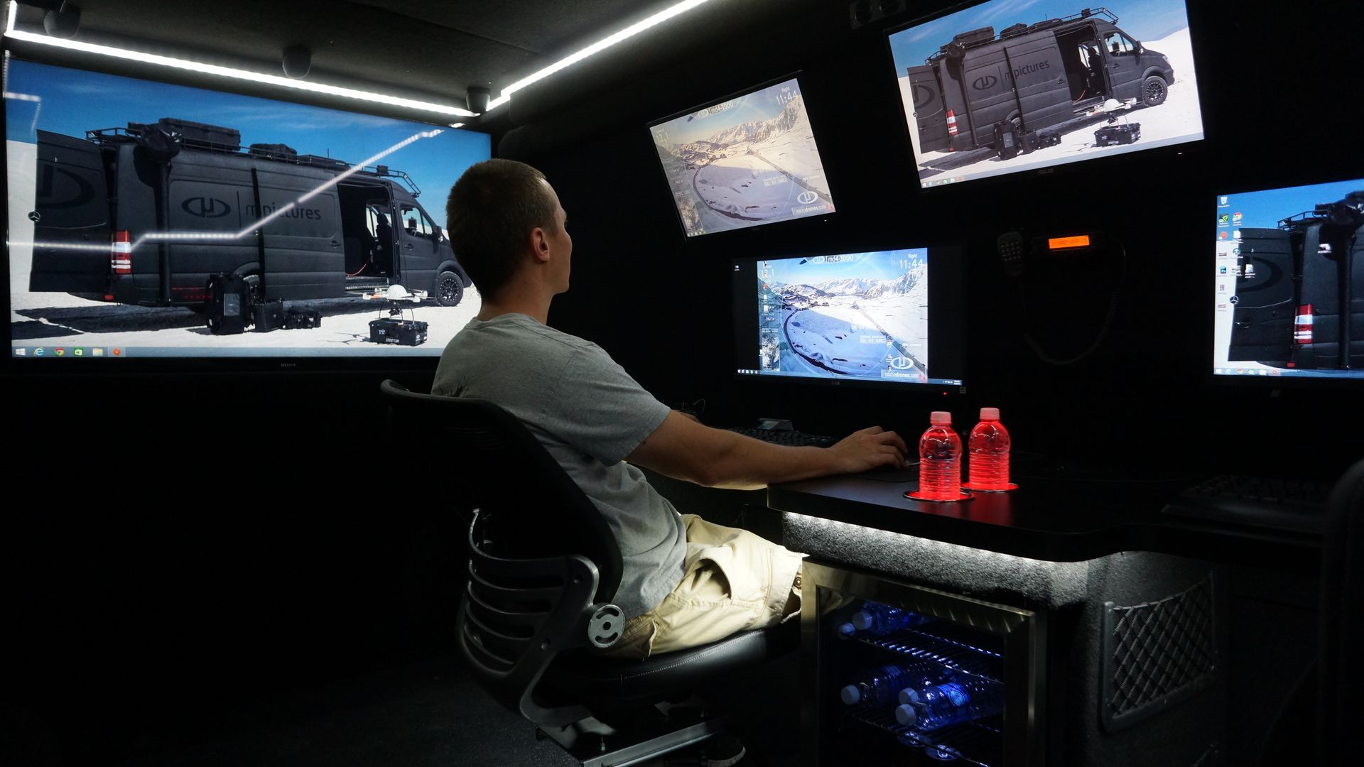 Inside the Tactical Mobile Workspace with a modular workstation setup adaptable for laptops and mobile devices, featuring swivel seats and a 360-degree operational view.