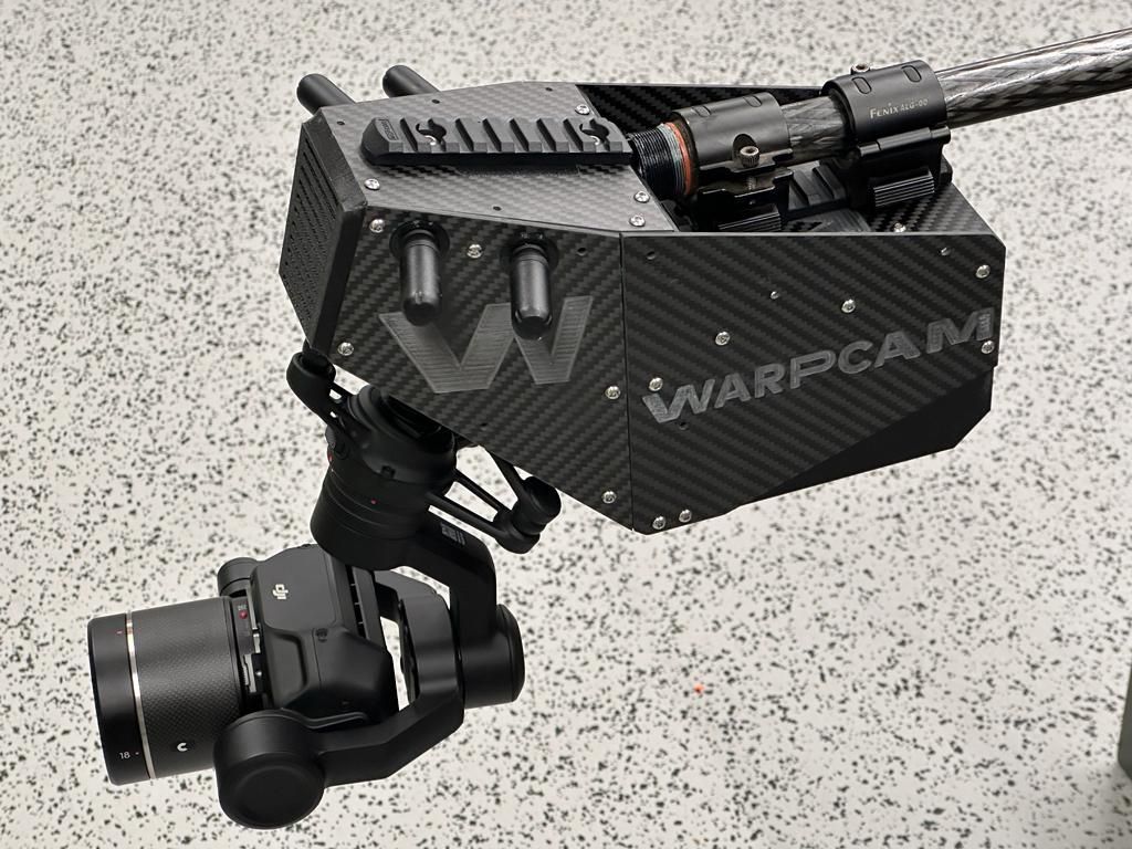 Close-up of the WarpCam® technology with its intricate lenses and stabilizers, ready for action on a film set, highlighting its advanced design and functionality