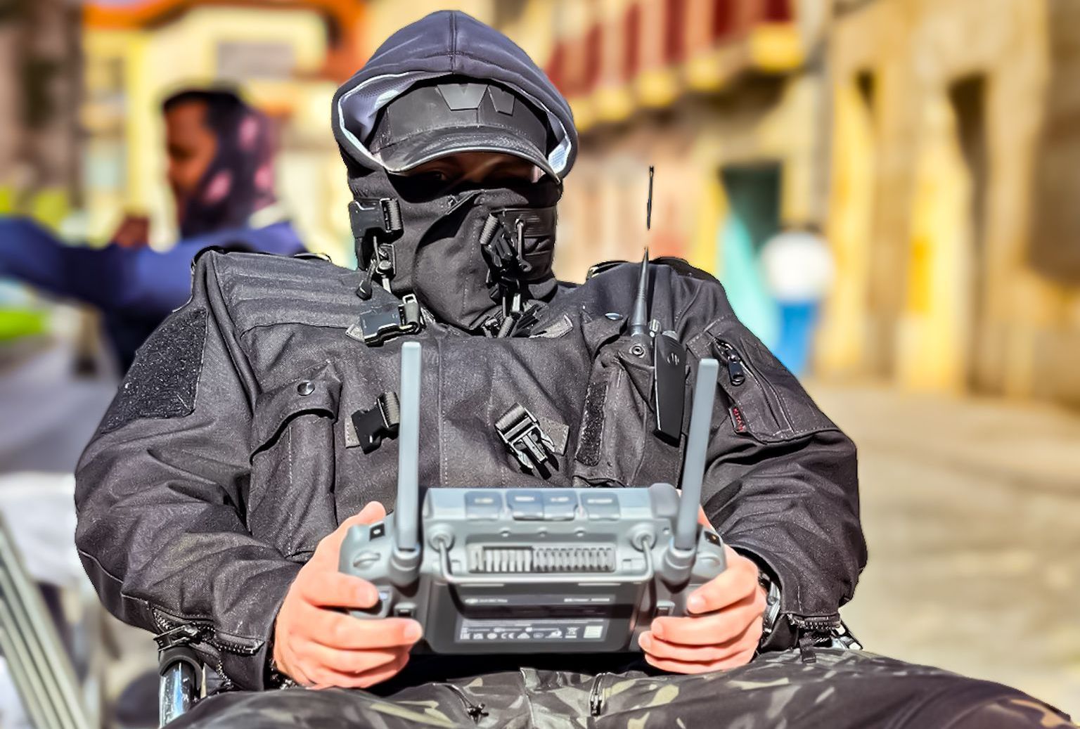 Ferdi Fischer sitting on a chair, holding a camera remote control for WarpCam®