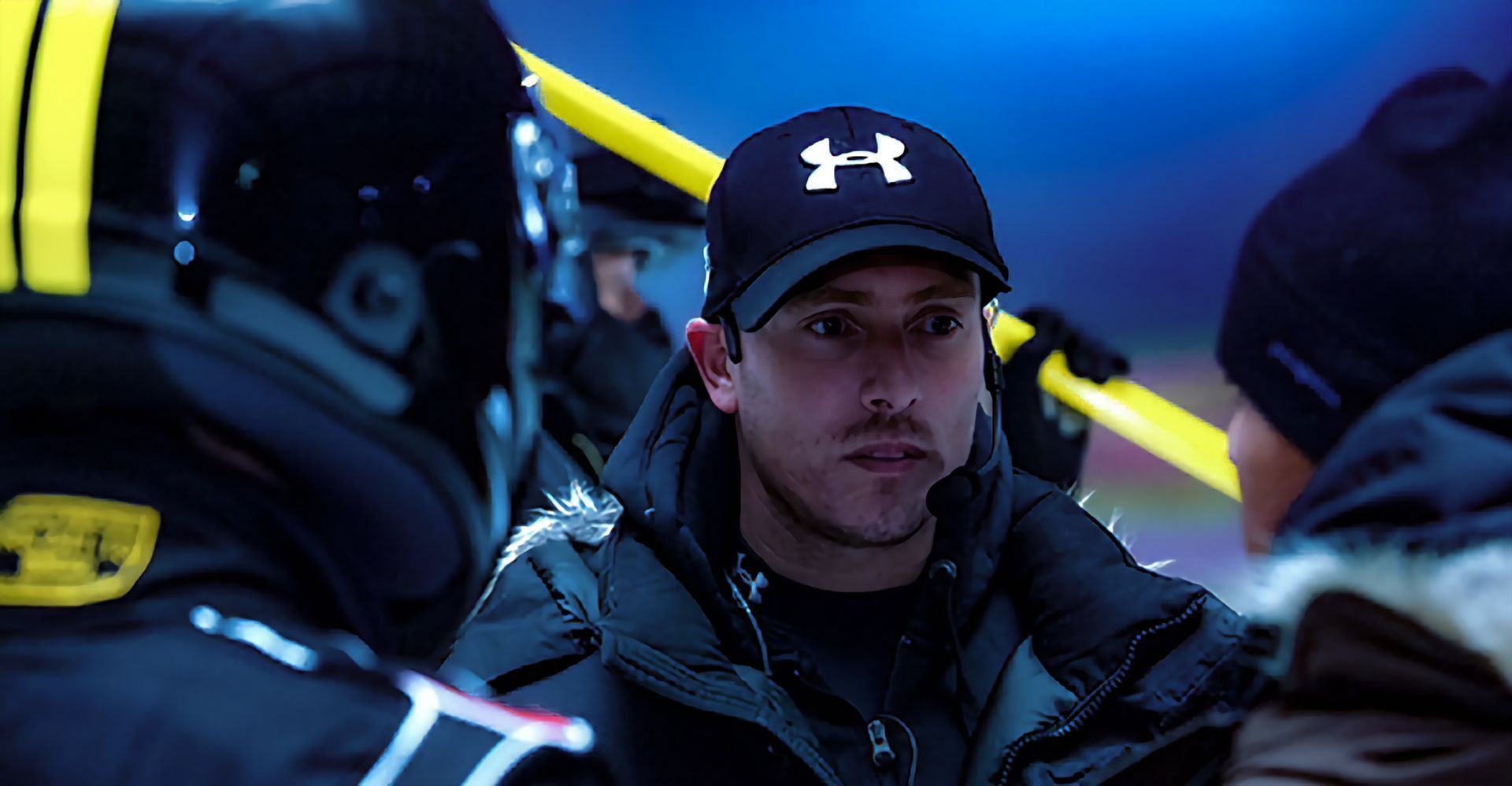 Stunt coordinator Ferdi is depicted giving instructions to a group of precision drivers