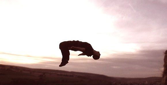 side and wide mid‑air shot of stuntman Ferdi Fischer during the world record 45 m fall into boxes