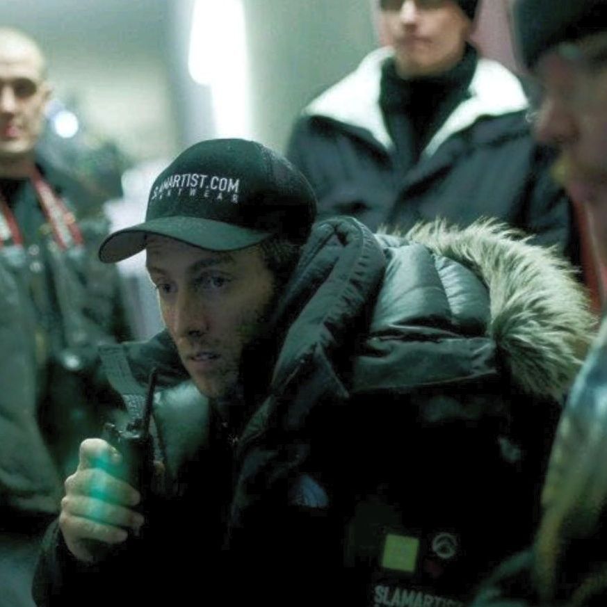 Action Director from slamartist.com checking the monitor with radio in hand