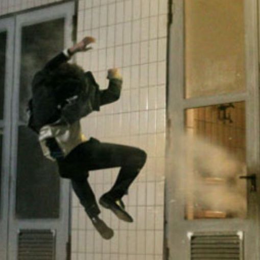 Stuntman Ferdi being pulled back rapidly by a ratchet system during a stunt setup, capturing the intense motion and preparation involved.