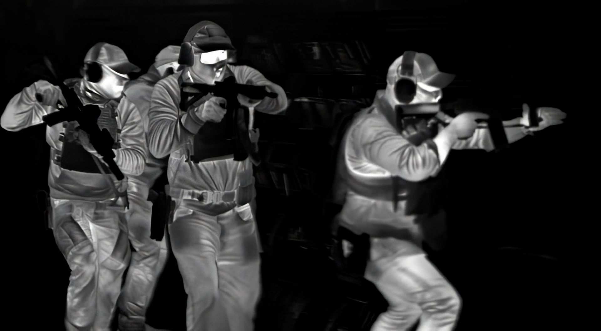 High-resolution thermal image of fully equipped tactical operators clearing a facility, their heat signatures vivid against the cooler background.