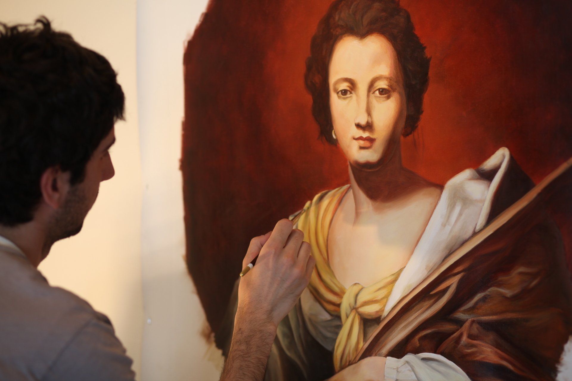 A man is painting a portrait of a woman