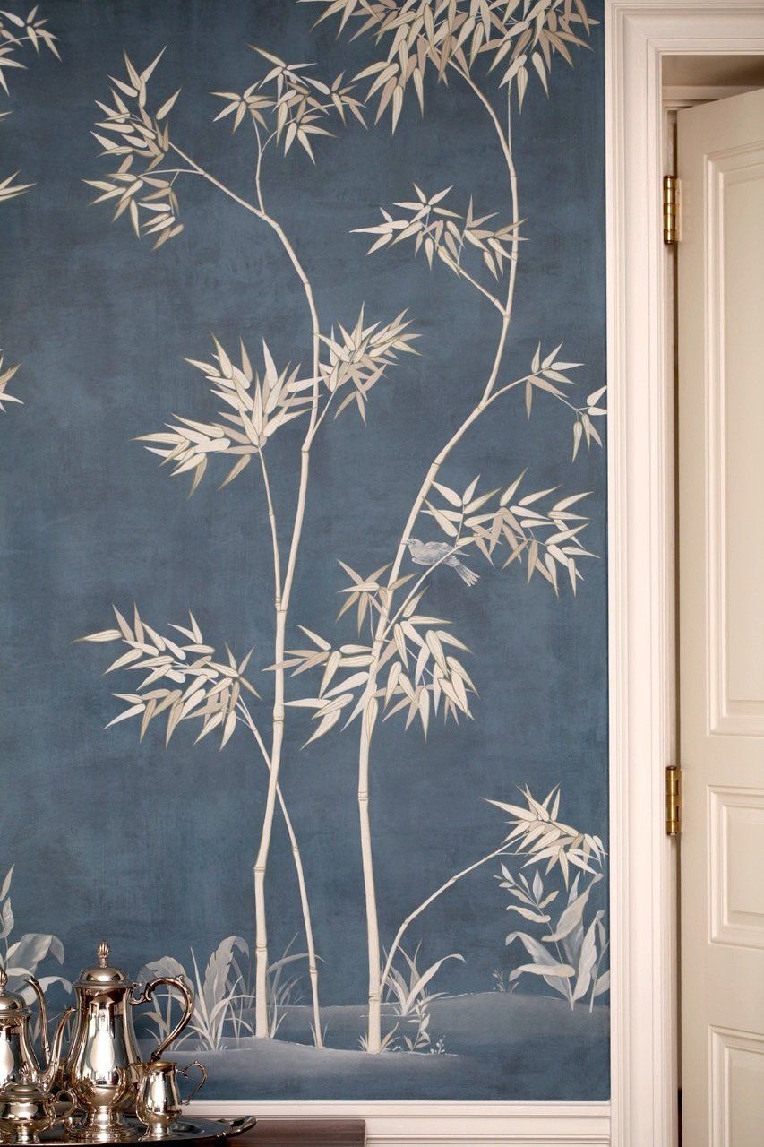 A wall with a painting of bamboo trees on it