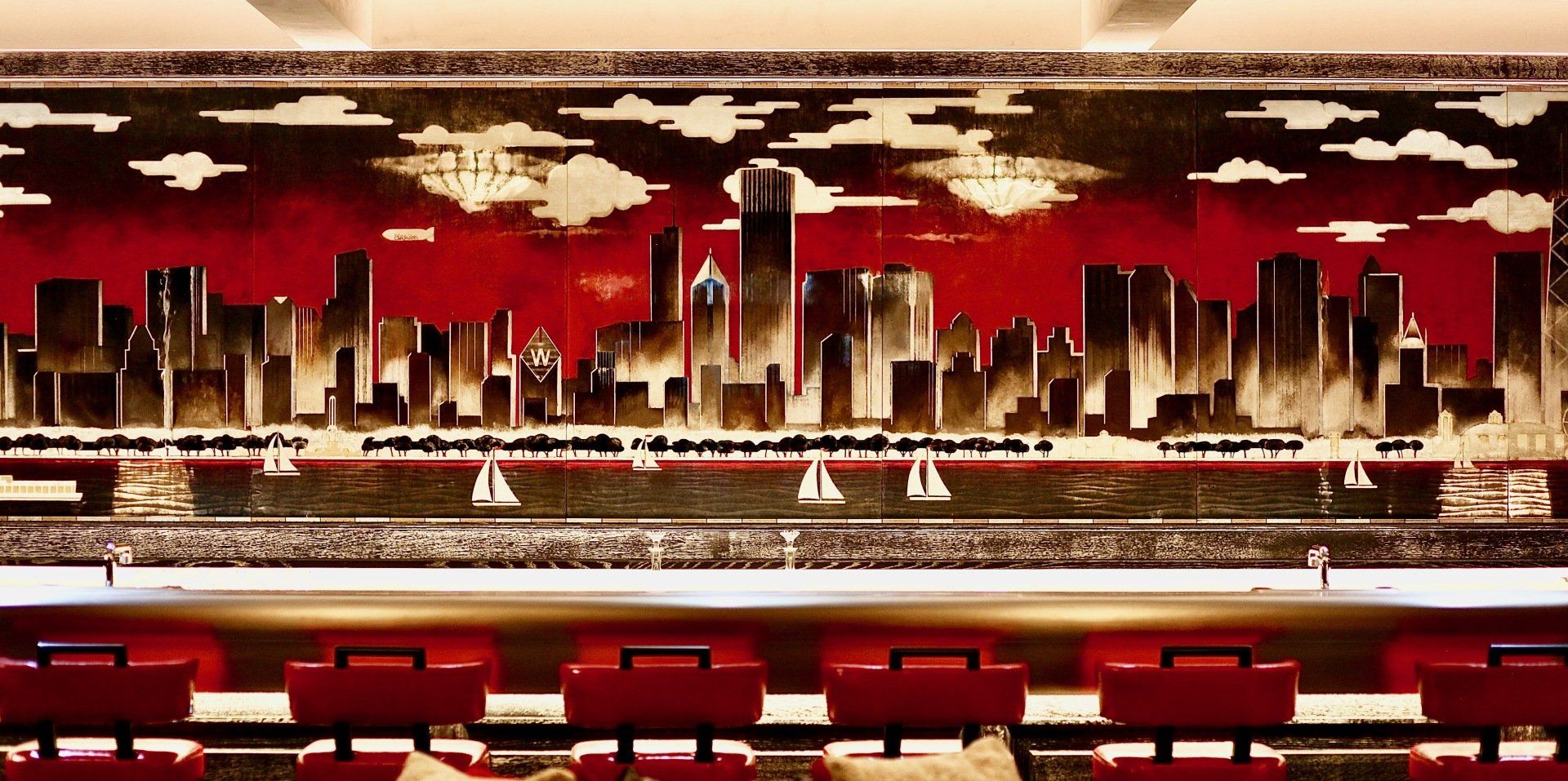 There is a painting of a city skyline on the wall.