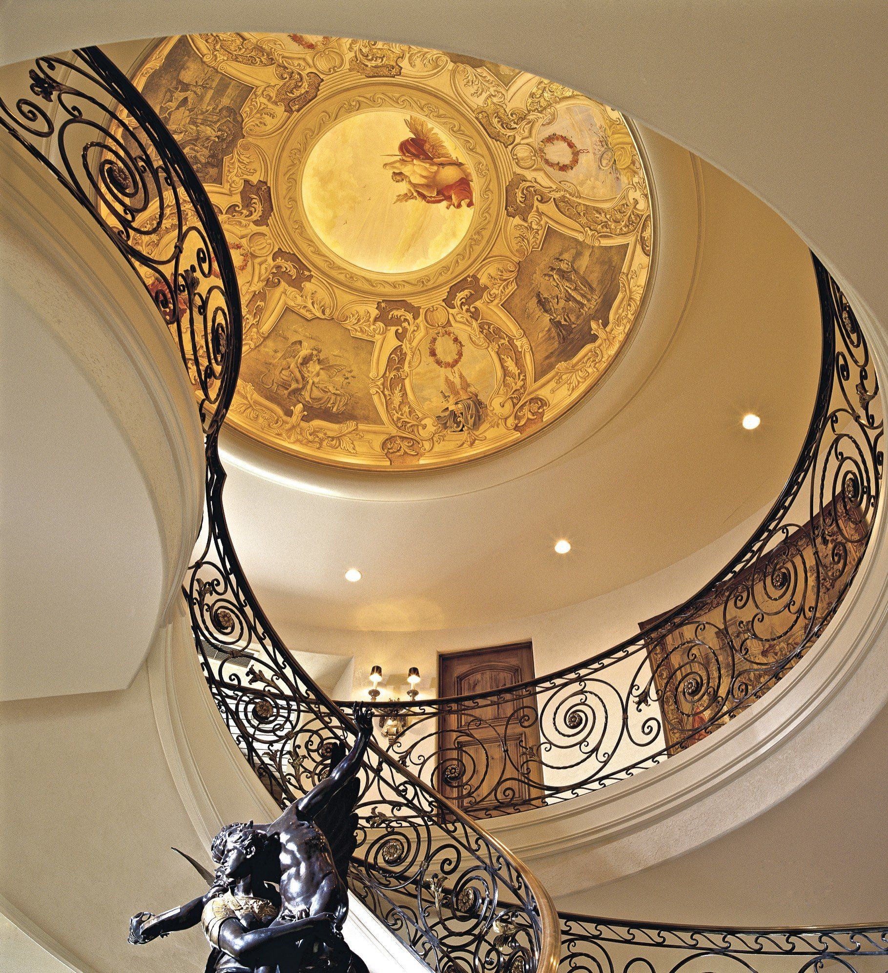 A spiral staircase with a dome in the ceiling