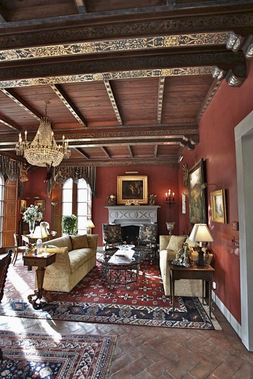 A living room with red walls and a fireplace