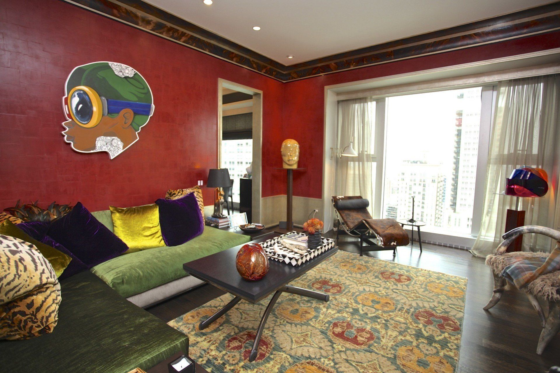 A living room with a green couch and a painting on the wall