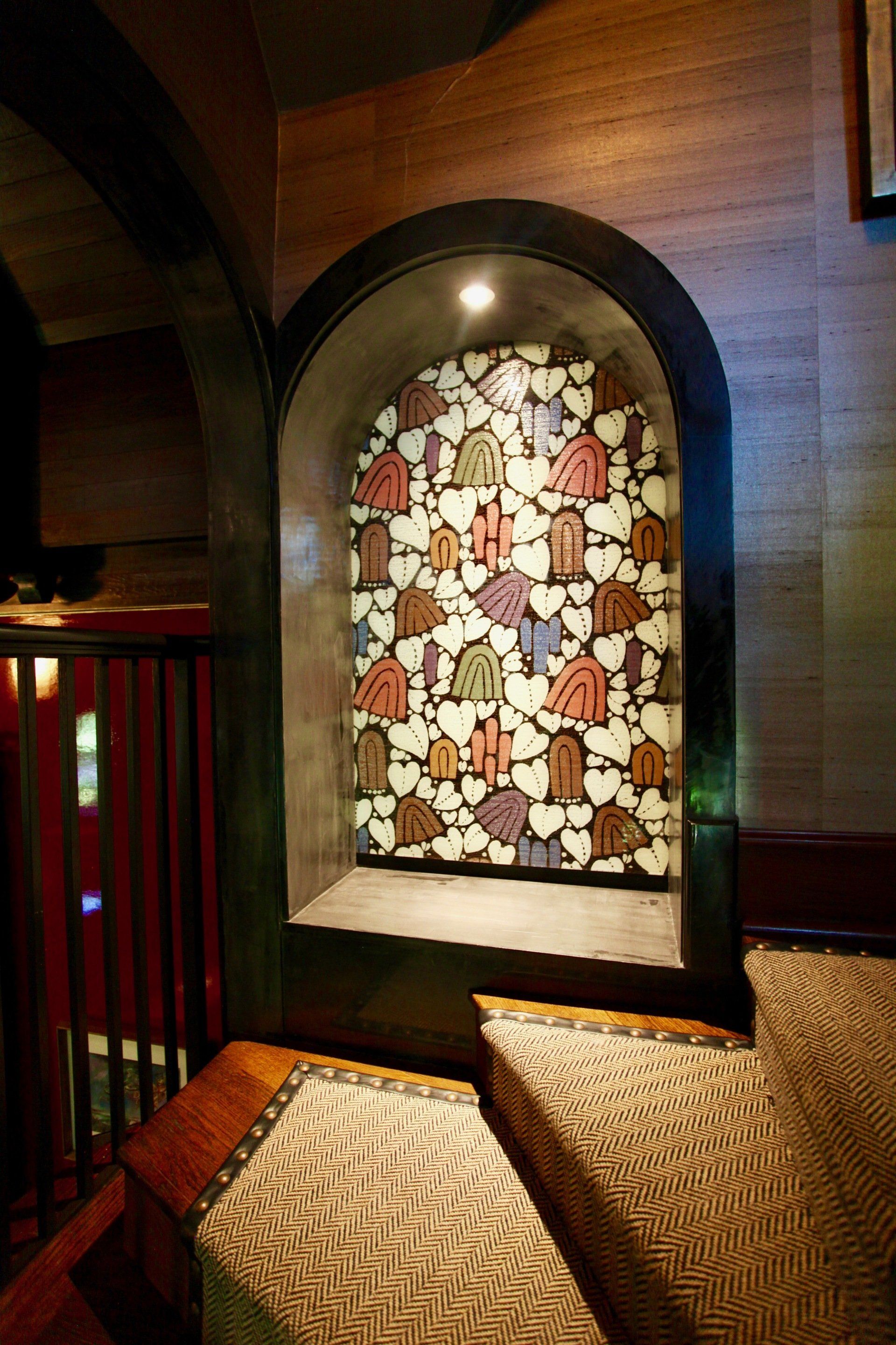 There is a stained glass window in the corner of the room.