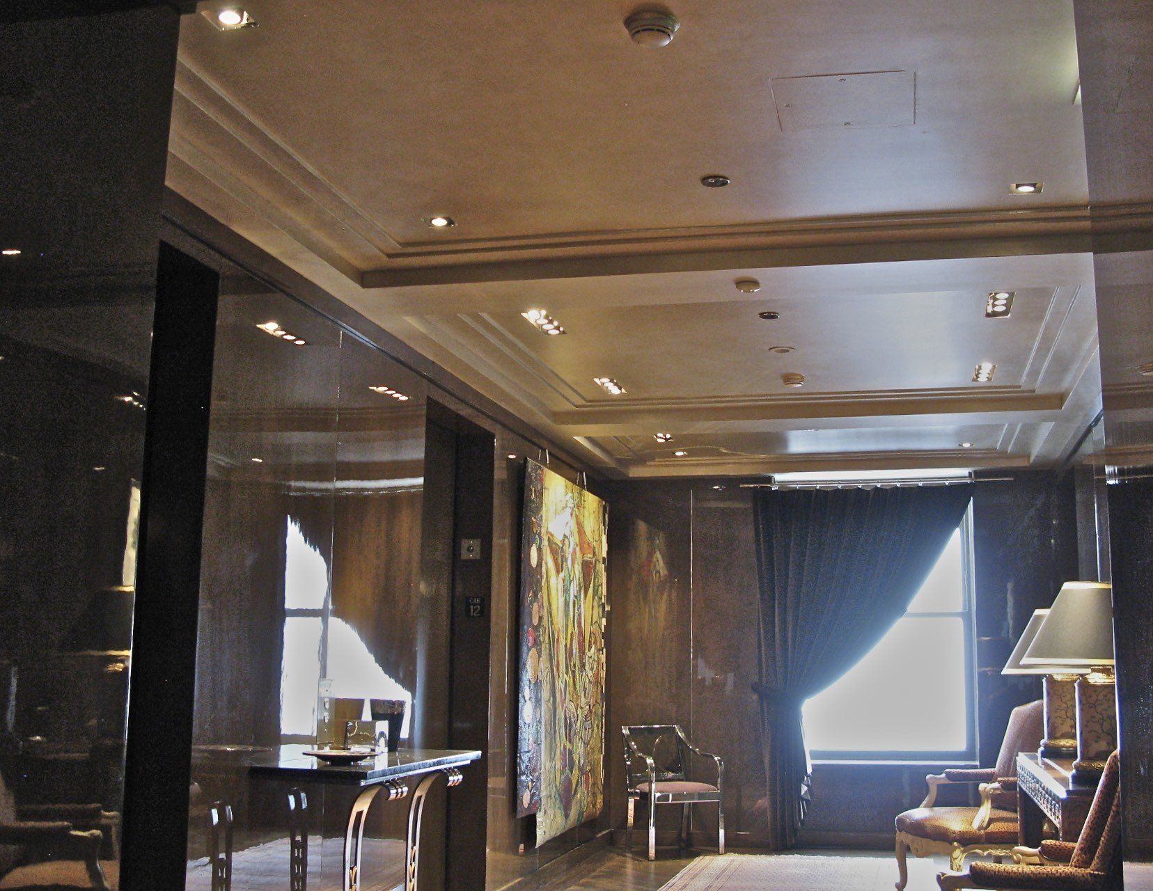 A living room with a table chairs and lamps