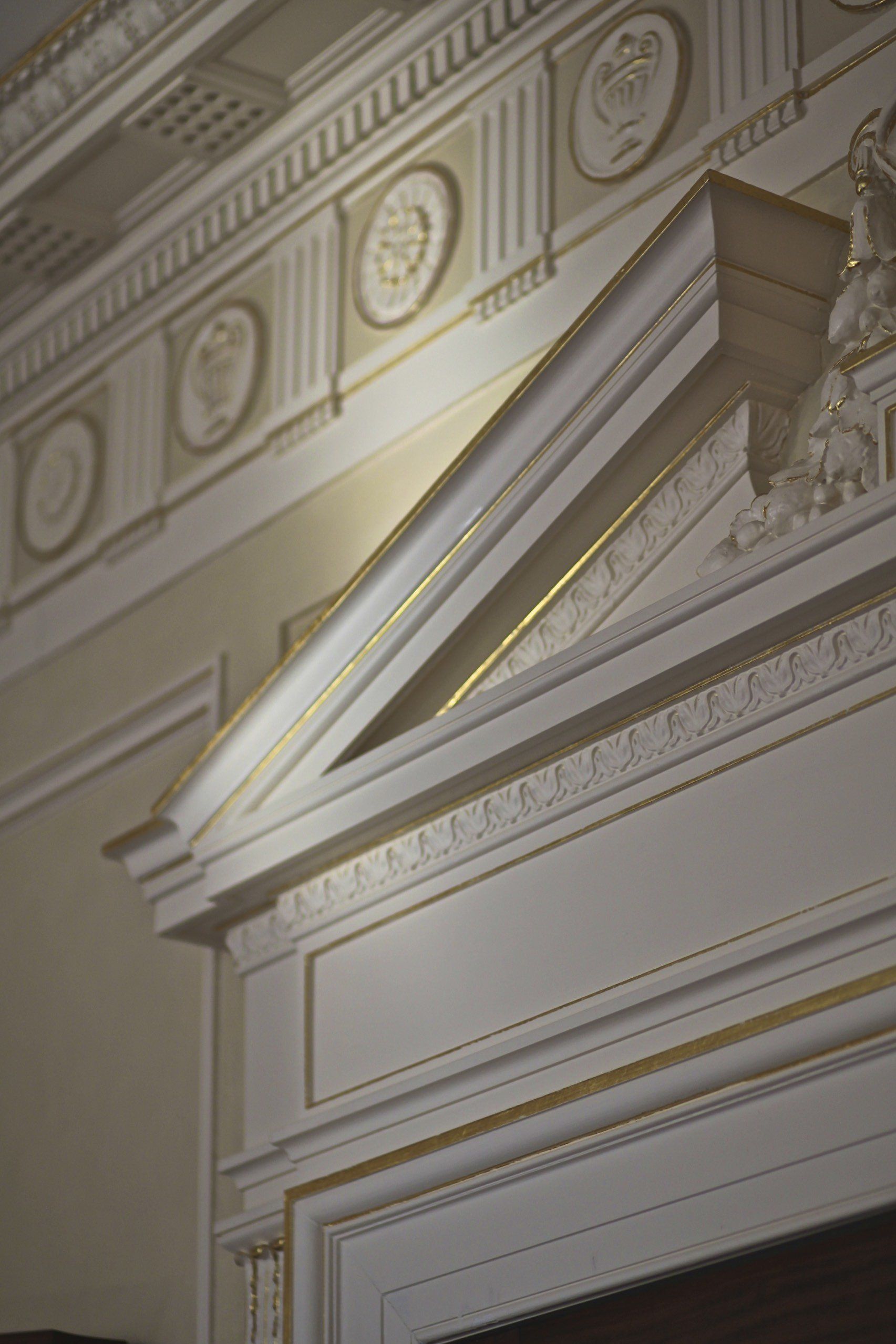 A close up of a white building with a gold trim