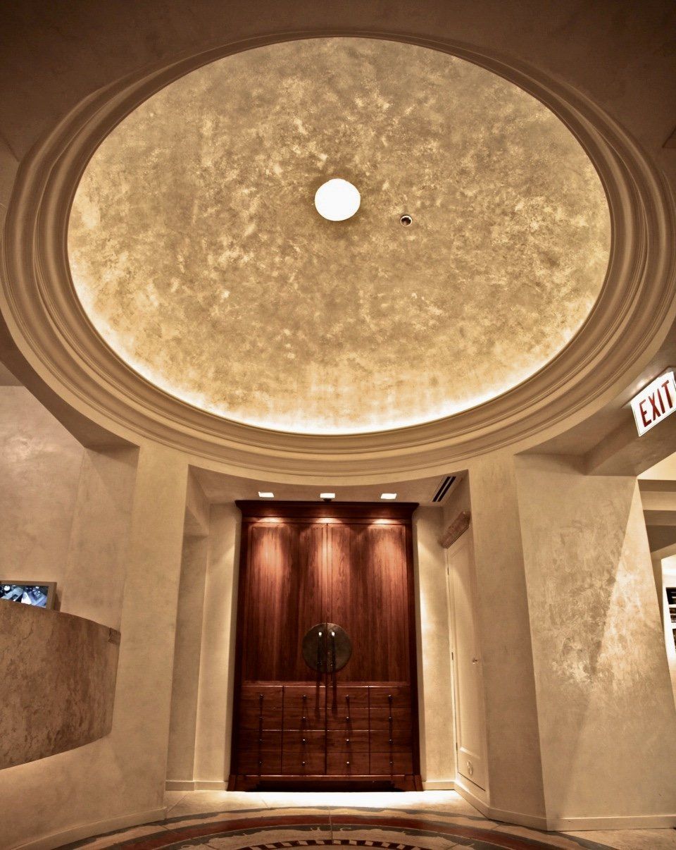 A hallway with a dome ceiling and an exit sign