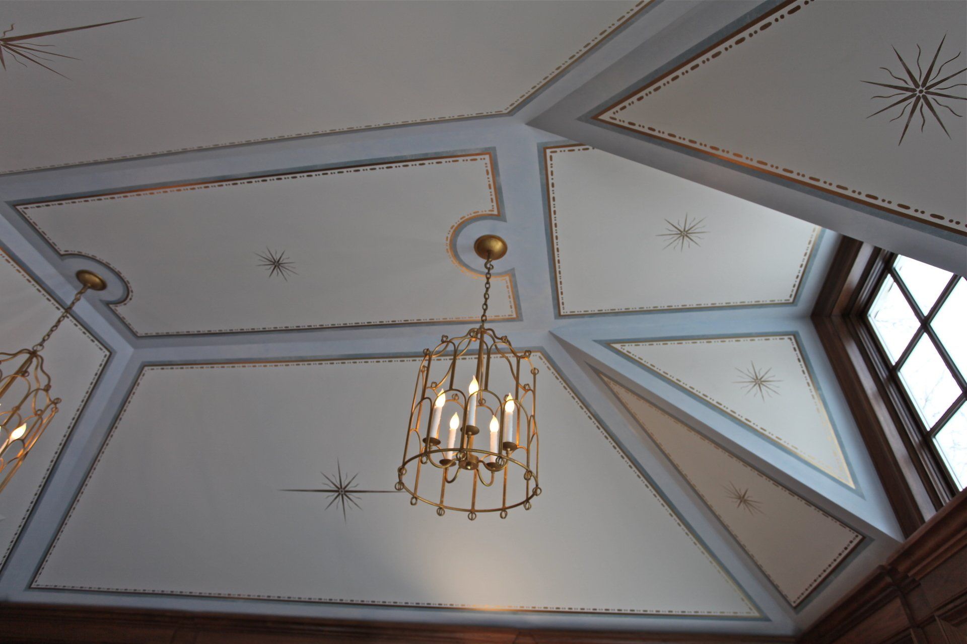A chandelier is hanging from the ceiling of a room
