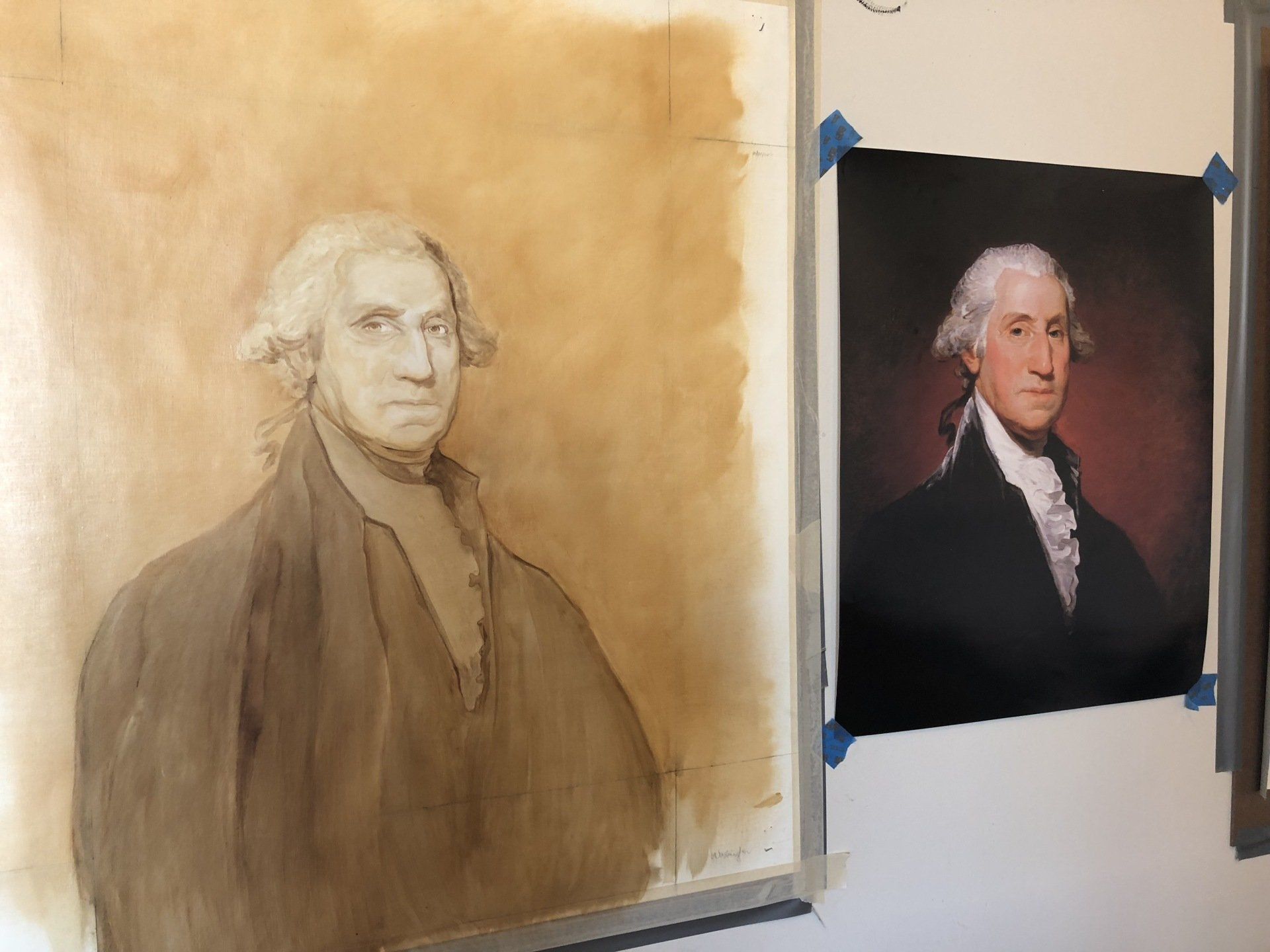 Two paintings of george washington are hanging on a wall.
