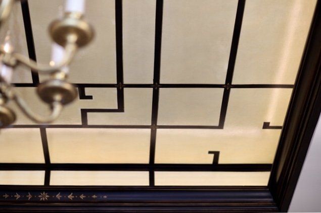 A chandelier is hanging from the ceiling of a room