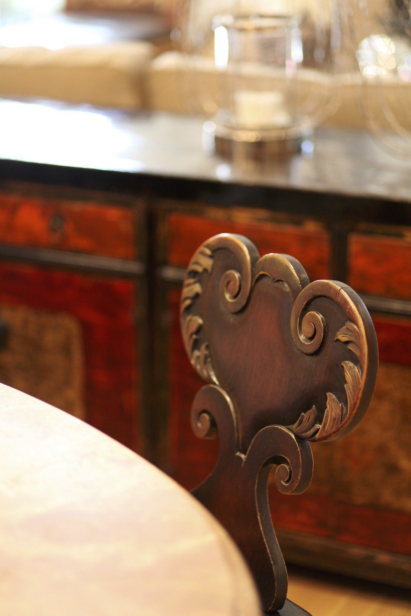 A chair with a heart shaped back sits in front of a table