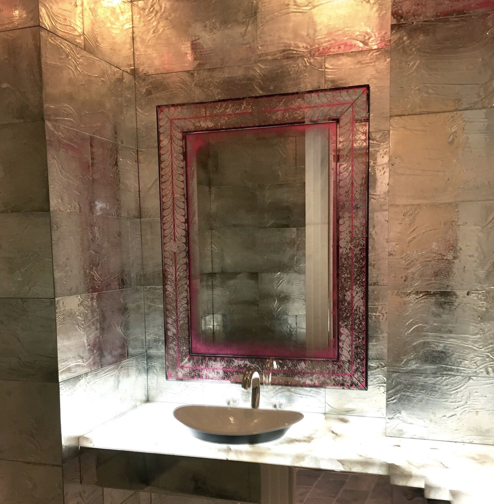 A bathroom with a sink and a mirror on the wall