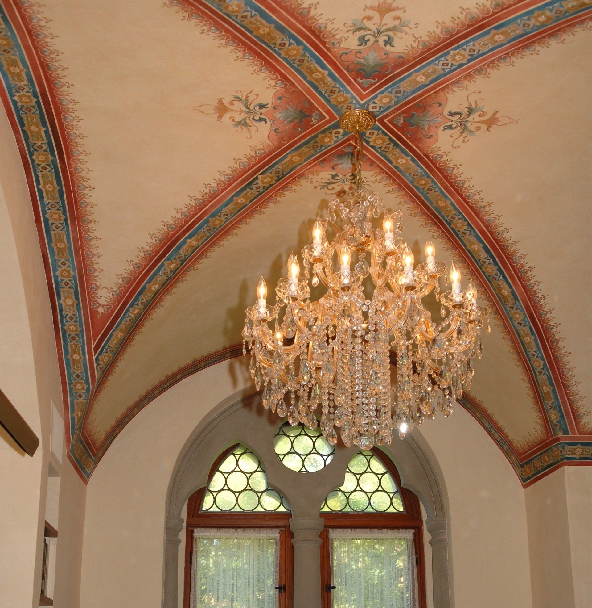 A chandelier hangs from the ceiling of a building