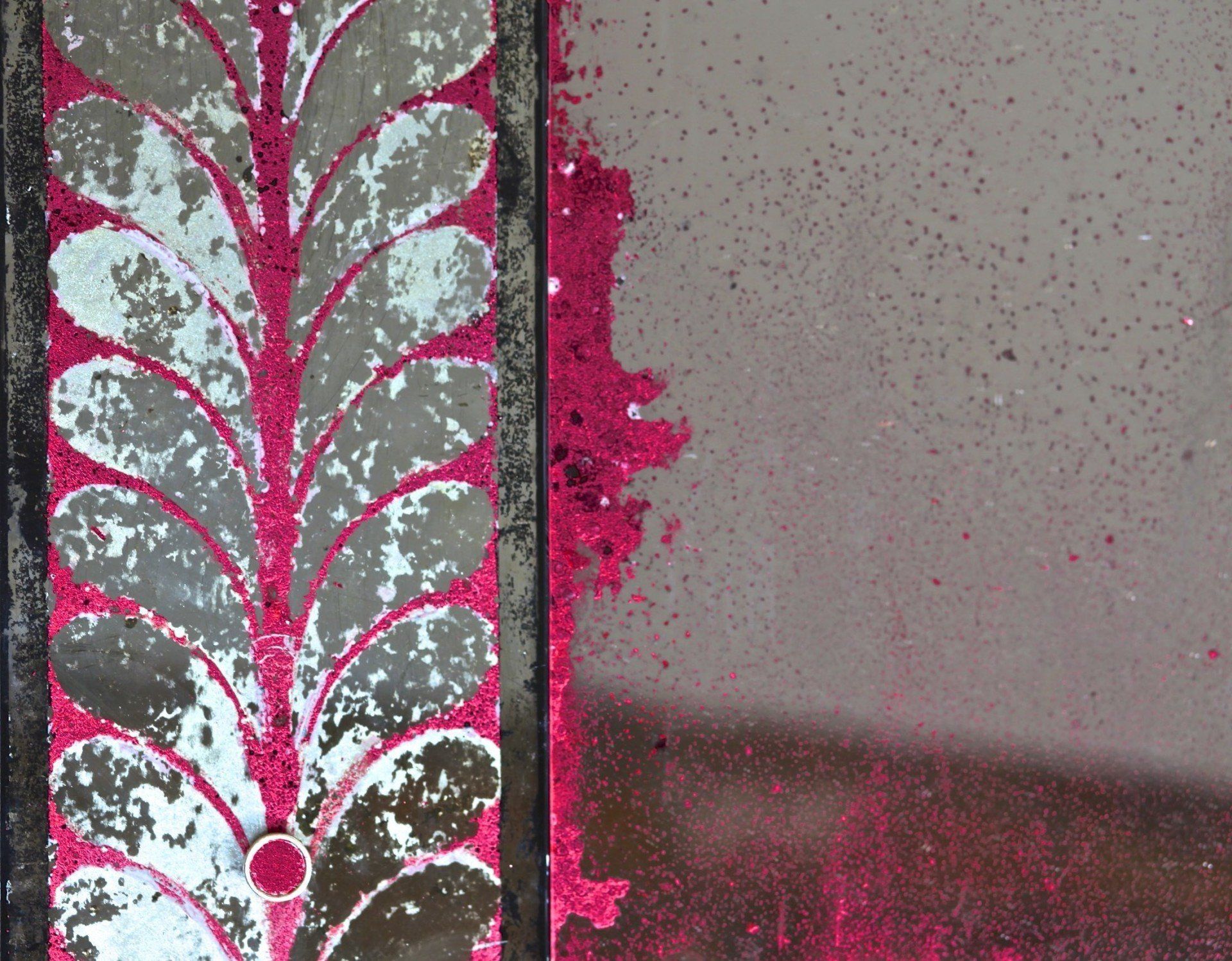 A close up of a mirror with a pink border
