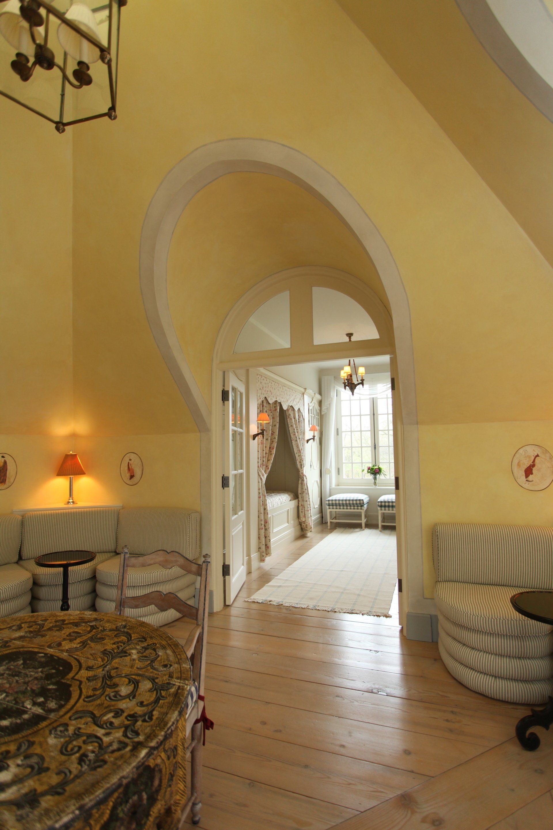 A living room with yellow walls and a wooden floor