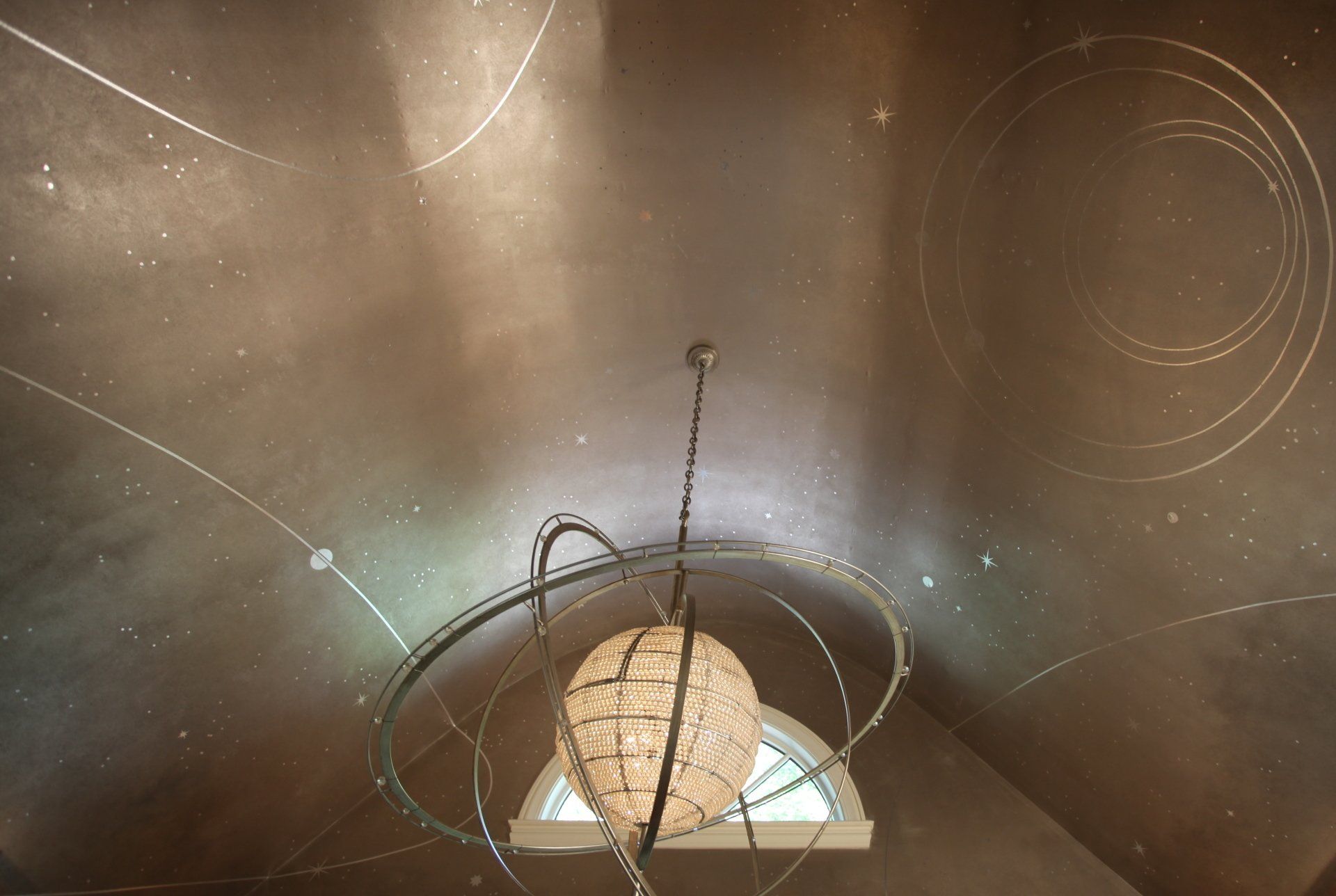 A chandelier is hanging from the ceiling in a room