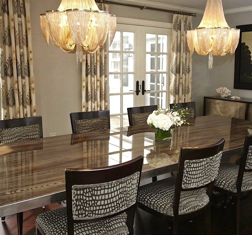 A dining room table with a vase of flowers on it