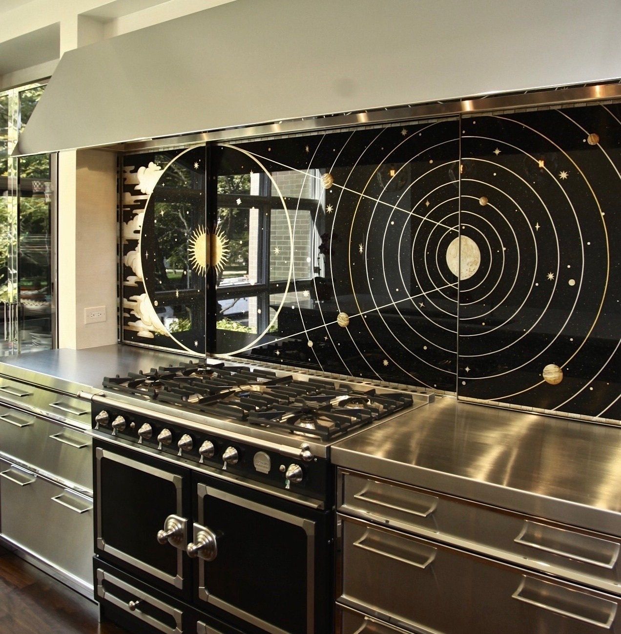 A kitchen with a stove top oven and drawers