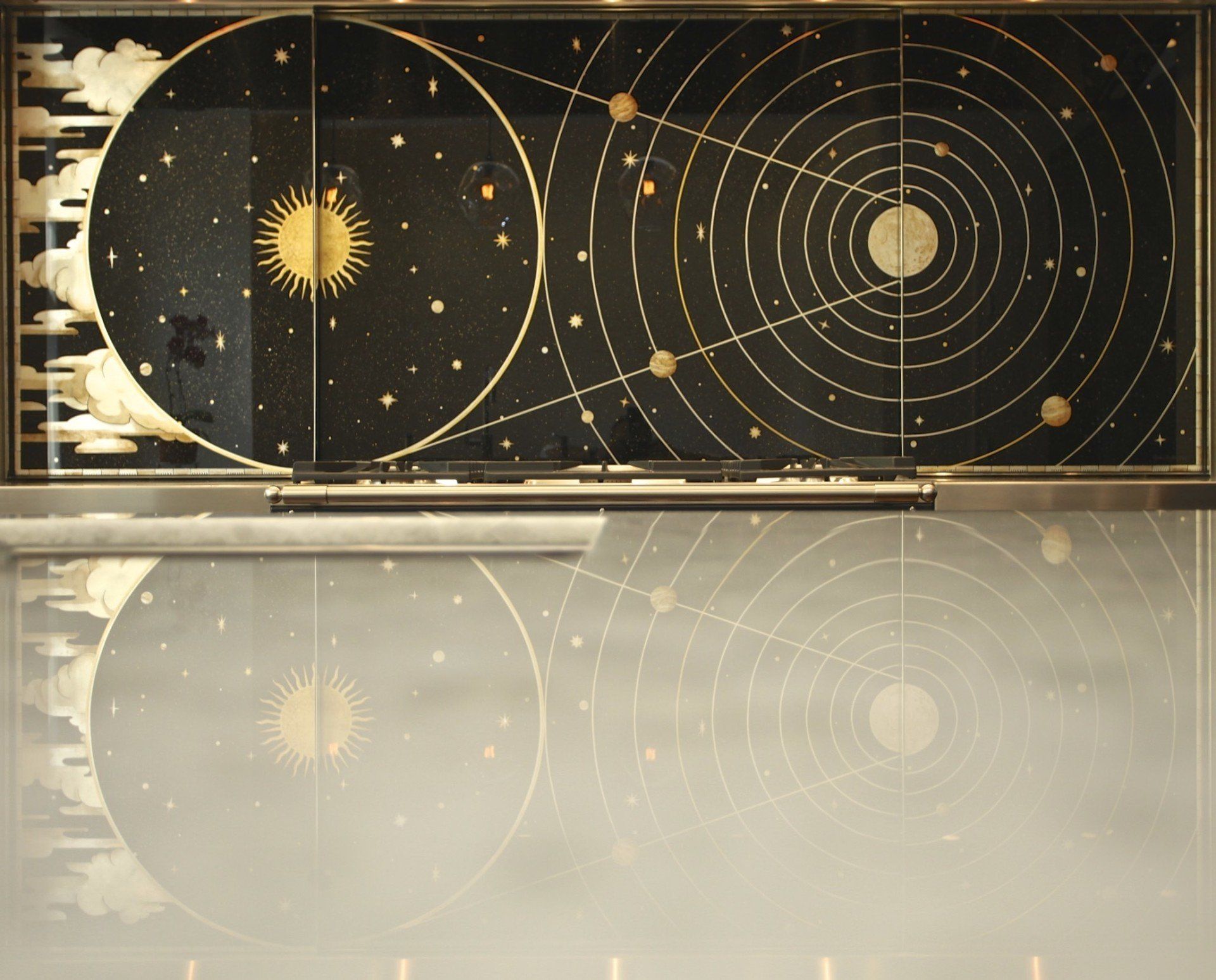 A black and gold painting of the solar system