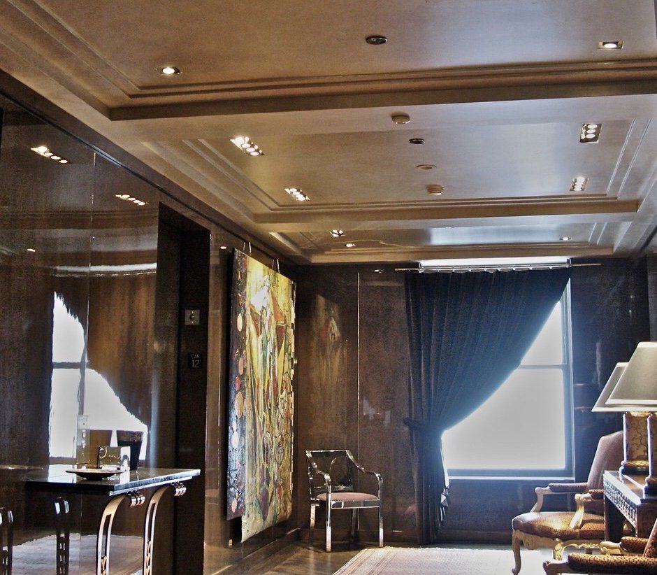 A living room with a table and chairs and a painting on the wall