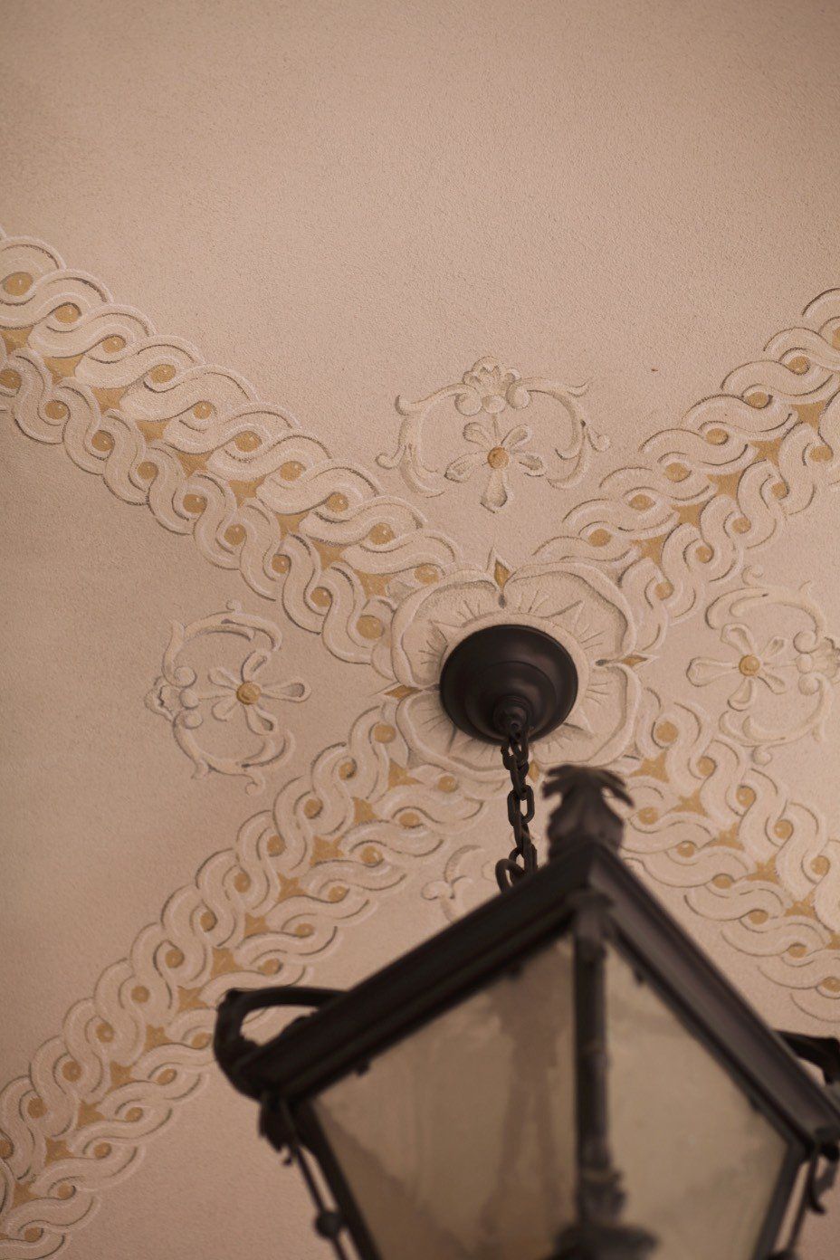 A lantern is hanging from the ceiling of a room.