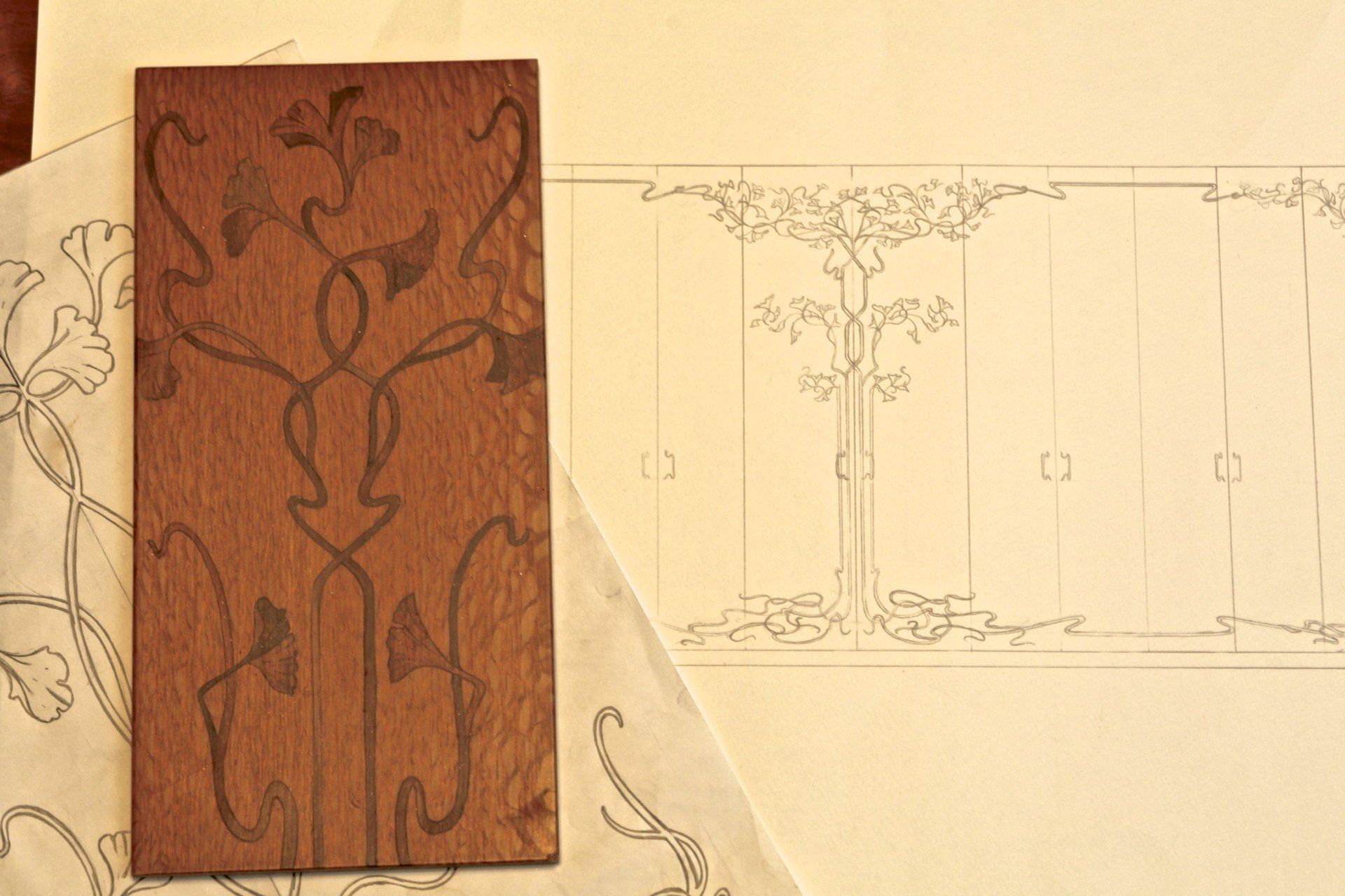 A piece of wood sitting next to a drawing of a tree